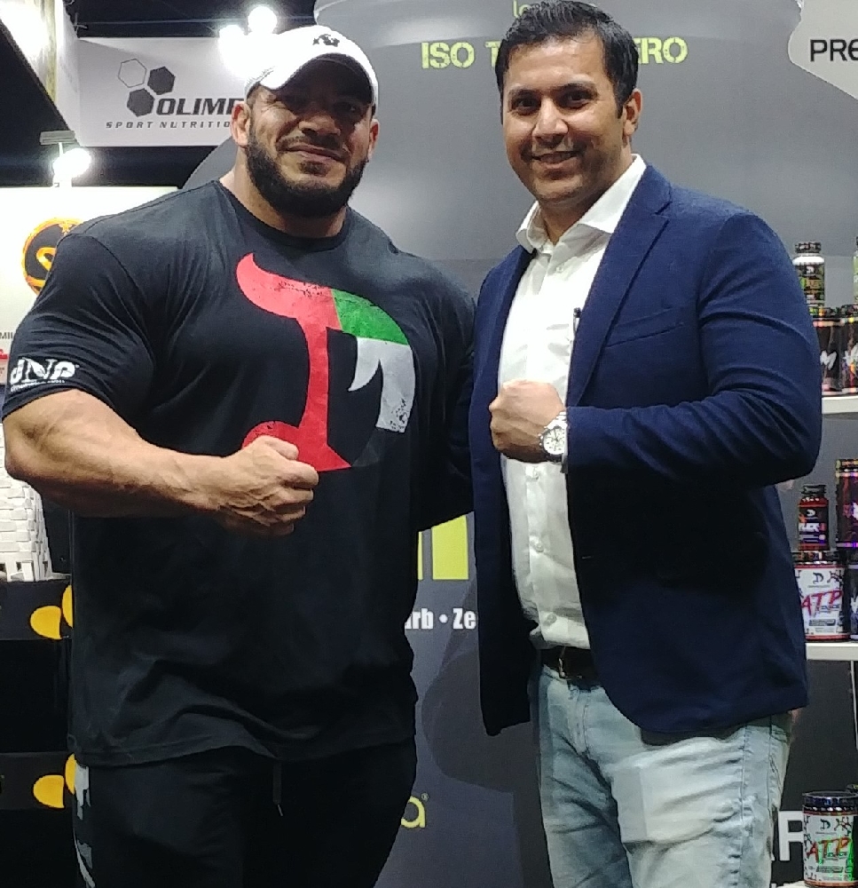Arif Khan, founder of MG Activewear, with a world champion bodybuilder at the Dubai Fitness Expo